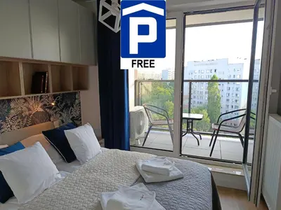 a bedroom with a bed with two towels on it at Cracowapart Sunny Point in Kraków