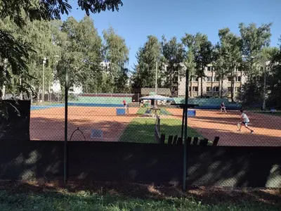 a park with people playing tennis on a tennis court at Cracowapart Sunny Point in Kraków