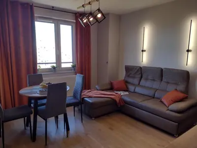 a living room with a couch and a table at Cracowapart Sunny Point in Kraków