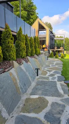 a stone path in front of a building with trees at Leśna Enklawa pod Wielką Górą in Pisarzowa