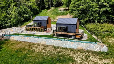 an aerial view of two houses on a hill at Leśna Enklawa pod Wielką Górą in Pisarzowa