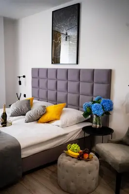 a bedroom with a large bed and a table with fruit on it at Susan Apartaments Kraków Kazimierz in Kraków