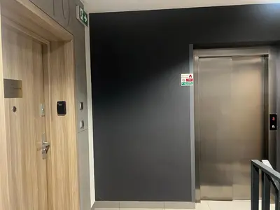a gray door in a building with a sign on it at Susan Apartaments Kraków Kazimierz in Kraków