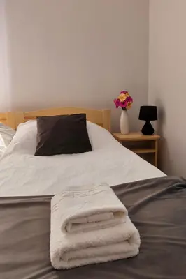 a bed with two towels laying on top of it at Noclegi Pod Lyskami in Nowy Targ