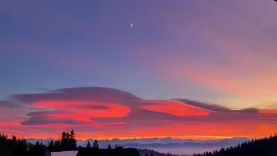 a sunset with red clouds in the sky at Noclegi Pod Lyskami in Nowy Targ