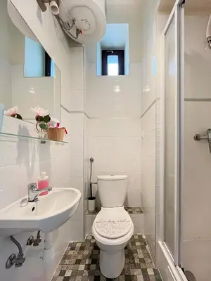 a white bathroom with a toilet and a sink at Smart Studio for 3 guests 8 min to Main Square in Kraków