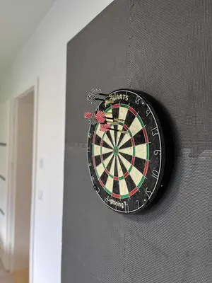 a dart board on the side of a wall at Bądź blisko in Jurków