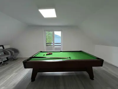 a pool table in a room with a window at Bądź blisko in Jurków