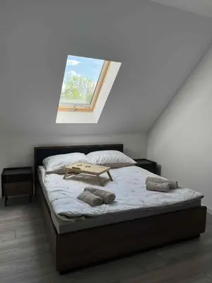 a bed in a room with a window at Bądź blisko in Jurków