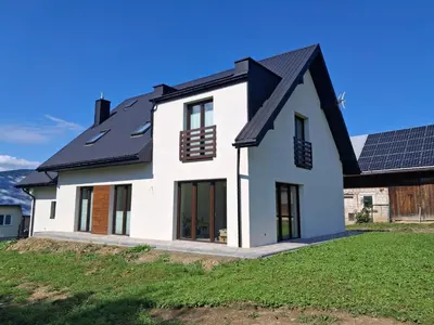 a house with solar panels on the roof at Bądź blisko in Jurków