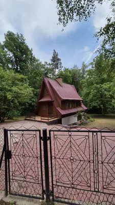 a building with a gate in front of a house at Chatka Cicho-Sza in Lanckorona