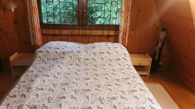 a bedroom with a bed in a room with a window at Chatka Cicho-Sza in Lanckorona