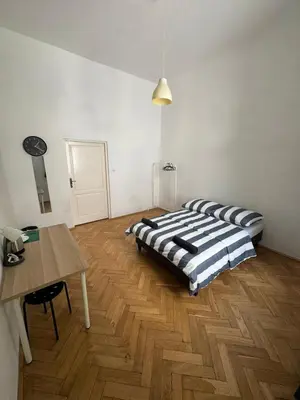 a bedroom with a bed and a table in it at Fantastic-Inn Kraków - Krasińskiego in Kraków