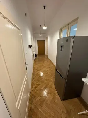 an empty hallway with a refrigerator in a room at Fantastic-Inn Kraków - Krasińskiego in Kraków