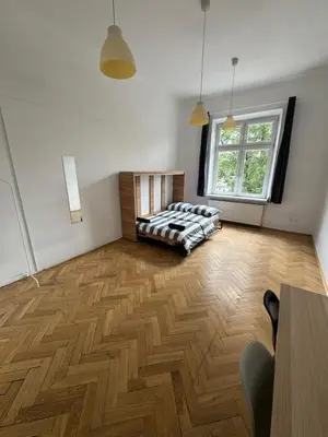 a large room with a bed in the middle of it at Fantastic-Inn Kraków - Krasińskiego in Kraków