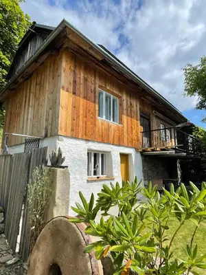 a wooden house with a fence in front of it at Podgórska 7 in Lanckorona