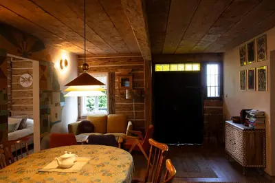 a room with a table and a living room with a couch at Podgórska 7 in Lanckorona