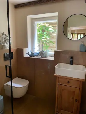 a bathroom with a toilet and a sink and a mirror at Podgórska 7 in Lanckorona