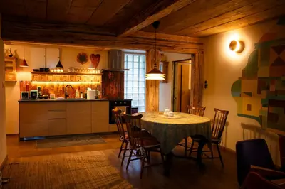 a kitchen and dining room with a table and chairs at Podgórska 7 in Lanckorona