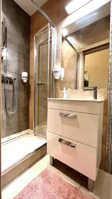 a bathroom with a sink and a shower at Studio in Kraków Center in Kraków