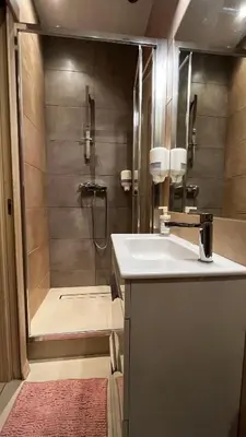 a bathroom with a shower with a sink and a tub at Studio in Kraków Center in Kraków