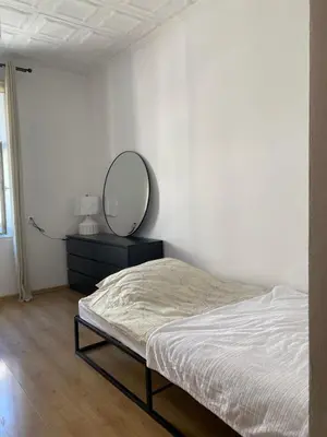 a bedroom with a bed and a mirror on a dresser at Luna Rooms in Kraków
