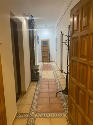 an empty hallway with a door and a tile floor at Luna Rooms in Kraków