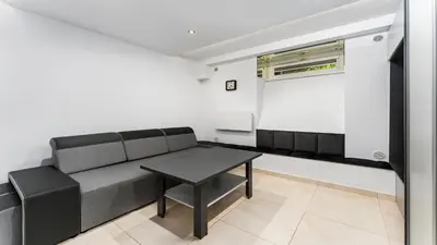 a living room with a couch and a table at Krasińskiego Comfort Studio by BookingHost in Kraków