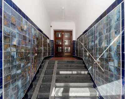 a hallway with blue tiles on the walls at Krasińskiego Comfort Studio by BookingHost in Kraków