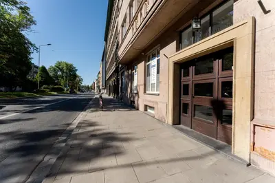 an empty street next to a building with two doors at Krasińskiego Comfort Studio by BookingHost in Kraków