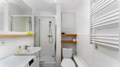 a bathroom with a toilet and a sink and a shower at Krasińskiego Comfort Studio by BookingHost in Kraków