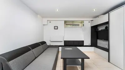 a living room with a couch and a table at Krasińskiego Comfort Studio by BookingHost in Kraków