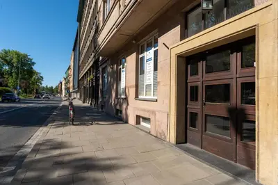 a bike parked on a sidewalk next to a building at Krasińskiego Comfort Studio by BookingHost in Kraków