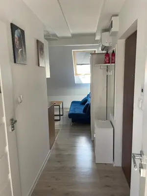 a hallway with a blue couch in a room at Old Town Escape in Kraków
