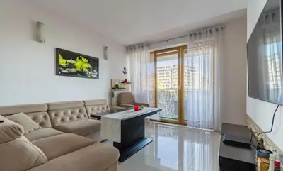 a living room with a couch and a table at Apartment with living room, kitchen, bedroom, bathroom in amazing neighborhood in Kraków
