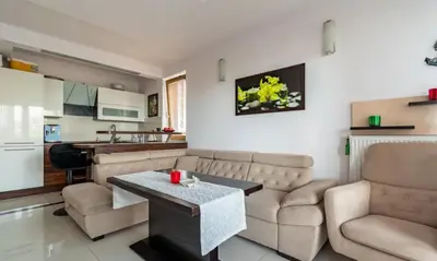 a living room with a couch and a table at Apartment with living room, kitchen, bedroom, bathroom in amazing neighborhood in Kraków