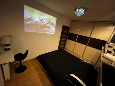 a bedroom with a bed and a desk and a lamp at Apartment with living room, kitchen, bedroom, bathroom in amazing neighborhood in Kraków
