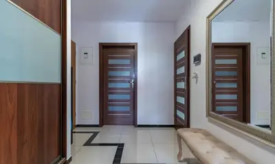 a hallway with two doors and a mirror at Apartment with living room, kitchen, bedroom, bathroom in amazing neighborhood in Kraków