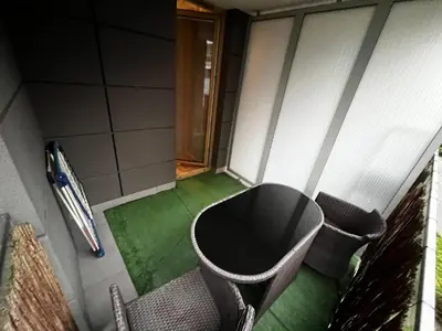 a room with a table and chairs on a green floor at Apartment with living room, kitchen, bedroom, bathroom in amazing neighborhood in Kraków