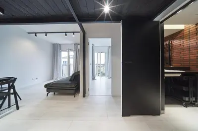 a living room with a bed and a table at Zabłocie Luxury Apartment WAWELOFTS in Kraków