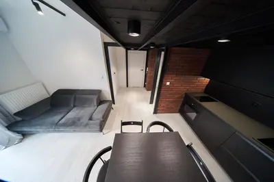 a room with a bed and a table and chairs at Zabłocie Luxury Apartment WAWELOFTS in Kraków