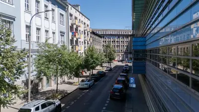 a city street with cars parked next to buildings at Topolowa Modern Studio by BookingHost in Kraków