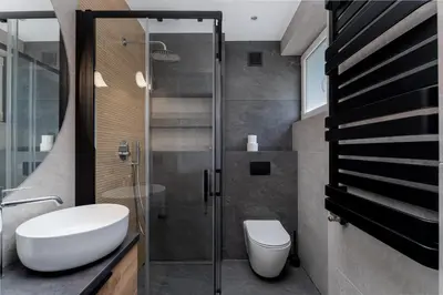 a bathroom with a toilet and a glass shower at Topolowa Modern Studio by BookingHost in Kraków