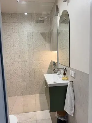 a bathroom with a shower and a sink and a mirror at Olszańska Gem in Kraków