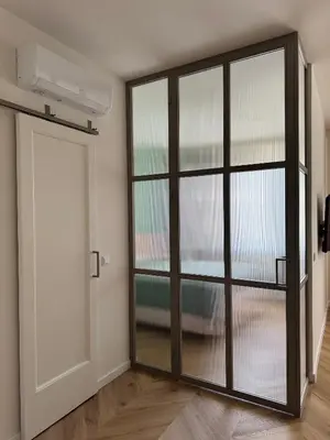 an empty room with a door and a window at Olszańska Gem in Kraków