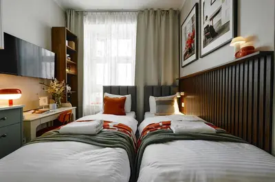 two beds sitting next to each other in a room at UR4N Apartment - Konarskiego in Kraków
