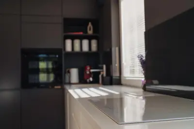 a kitchen with a white counter top and a window at Białoprądnicka - Stay&Park in Kraków