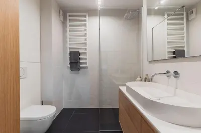 a white bathroom with a sink and a toilet at Białoprądnicka - Stay&Park in Kraków