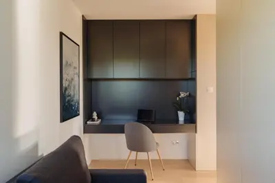 a living room with a blue couch and a table at Białoprądnicka - Stay&Park in Kraków