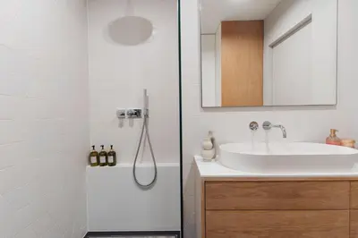 a bathroom with a sink and a shower at Białoprądnicka - Stay&Park in Kraków